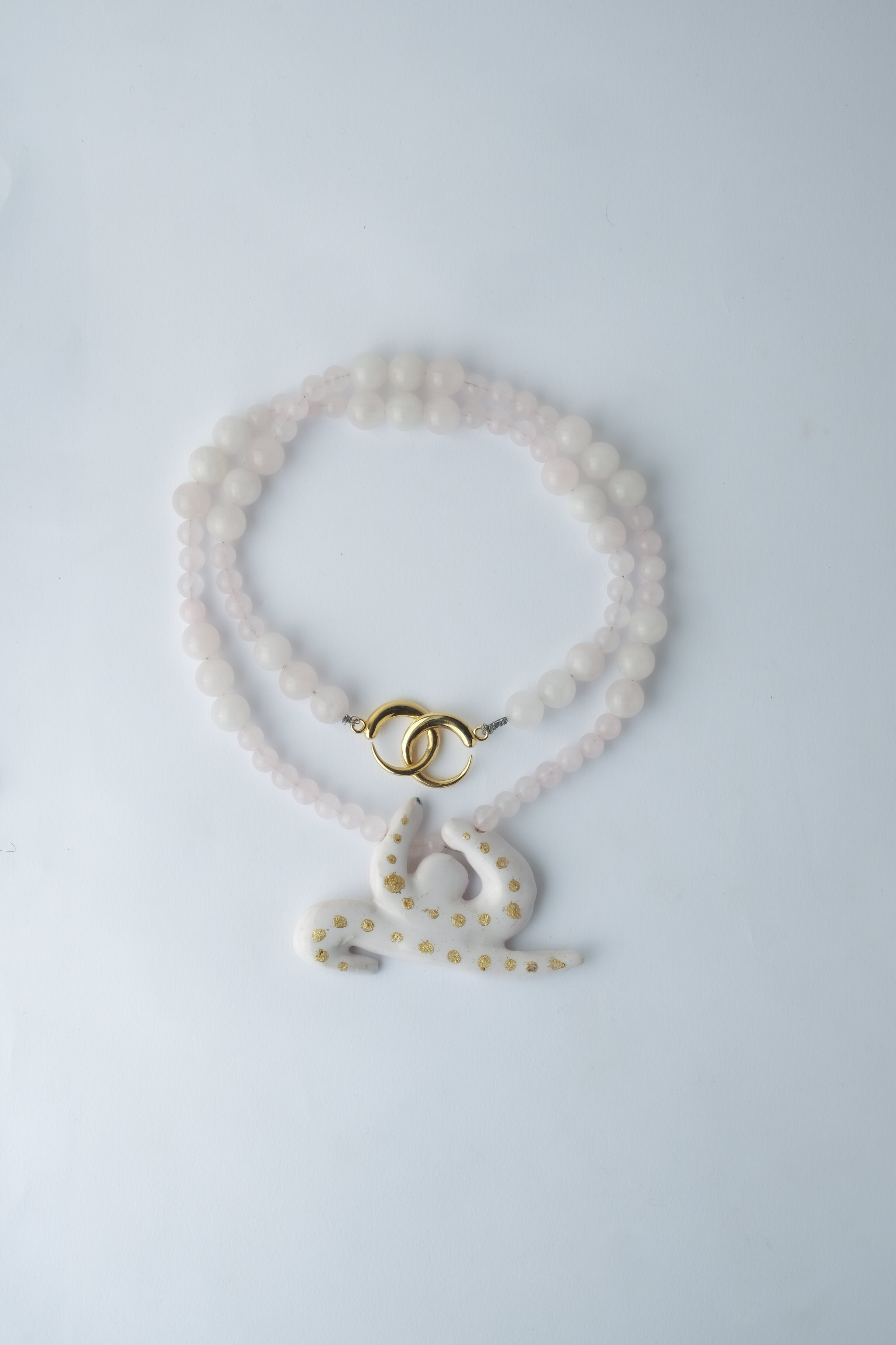 1/1 – Porcelain and Gold Leaf Leaping Forward Pendant on Quartz Beaded Cord
